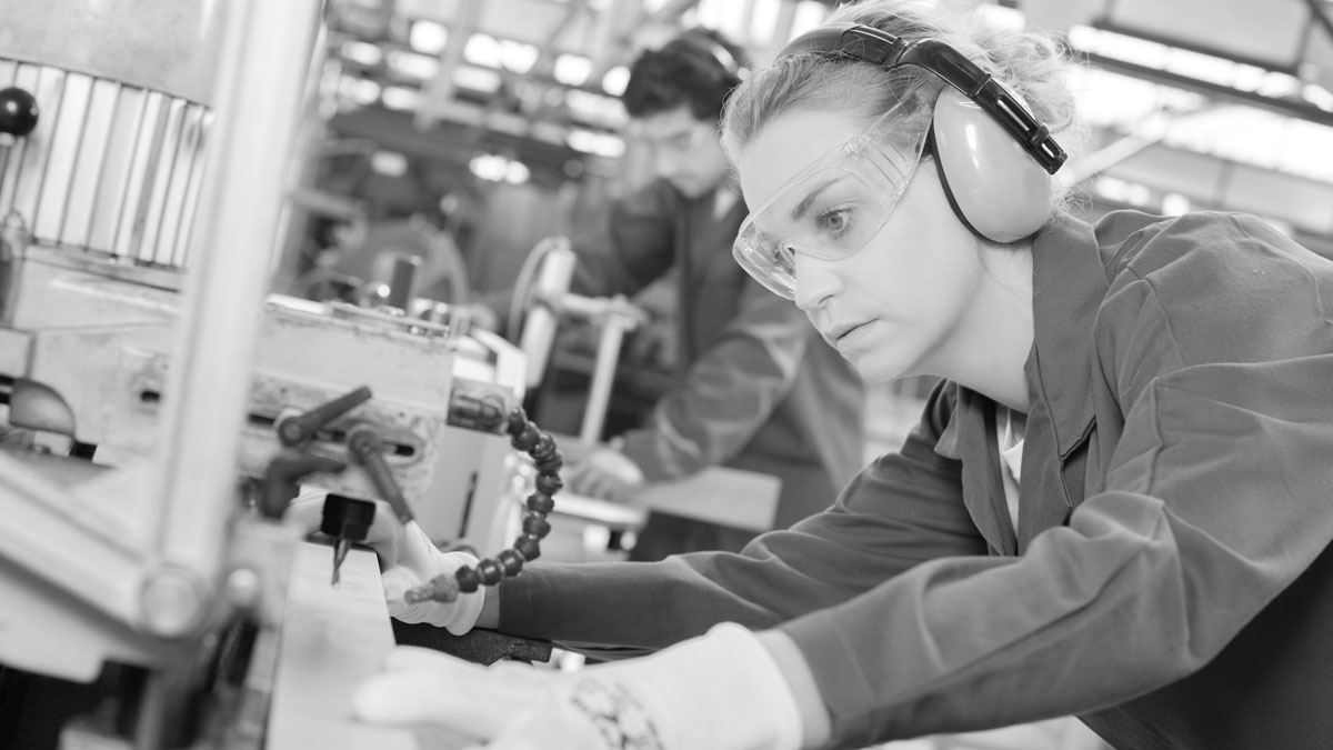 Woman using industrial machine